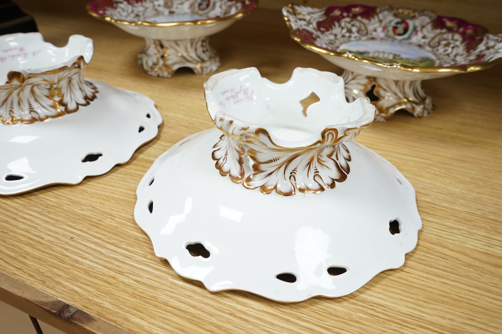 Four G Grainger, Worcester armorial porcelain comports, c.1845, hand painted with named views of Worcester, 24cm in diameter